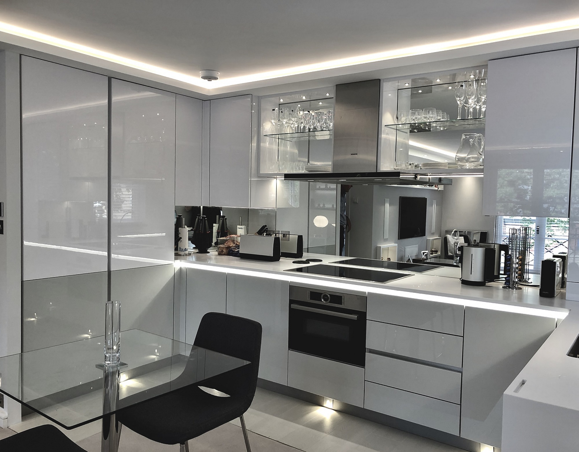 Designer White Kitchen for London pied-a-terre apartment, units are Hacker-Systemat high gloss grey lacquer with the upper units in high gloss white