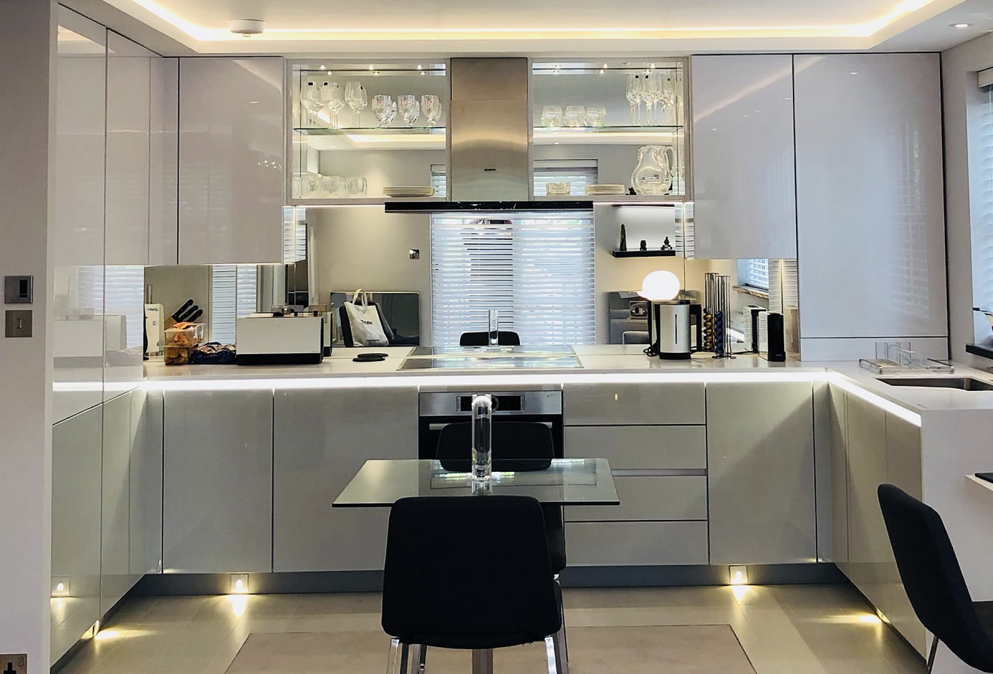 Designer White Kitchen for London pied-a-terre apartment, units are Hacker-Systemat high gloss grey lacquer with the upper units in high gloss white