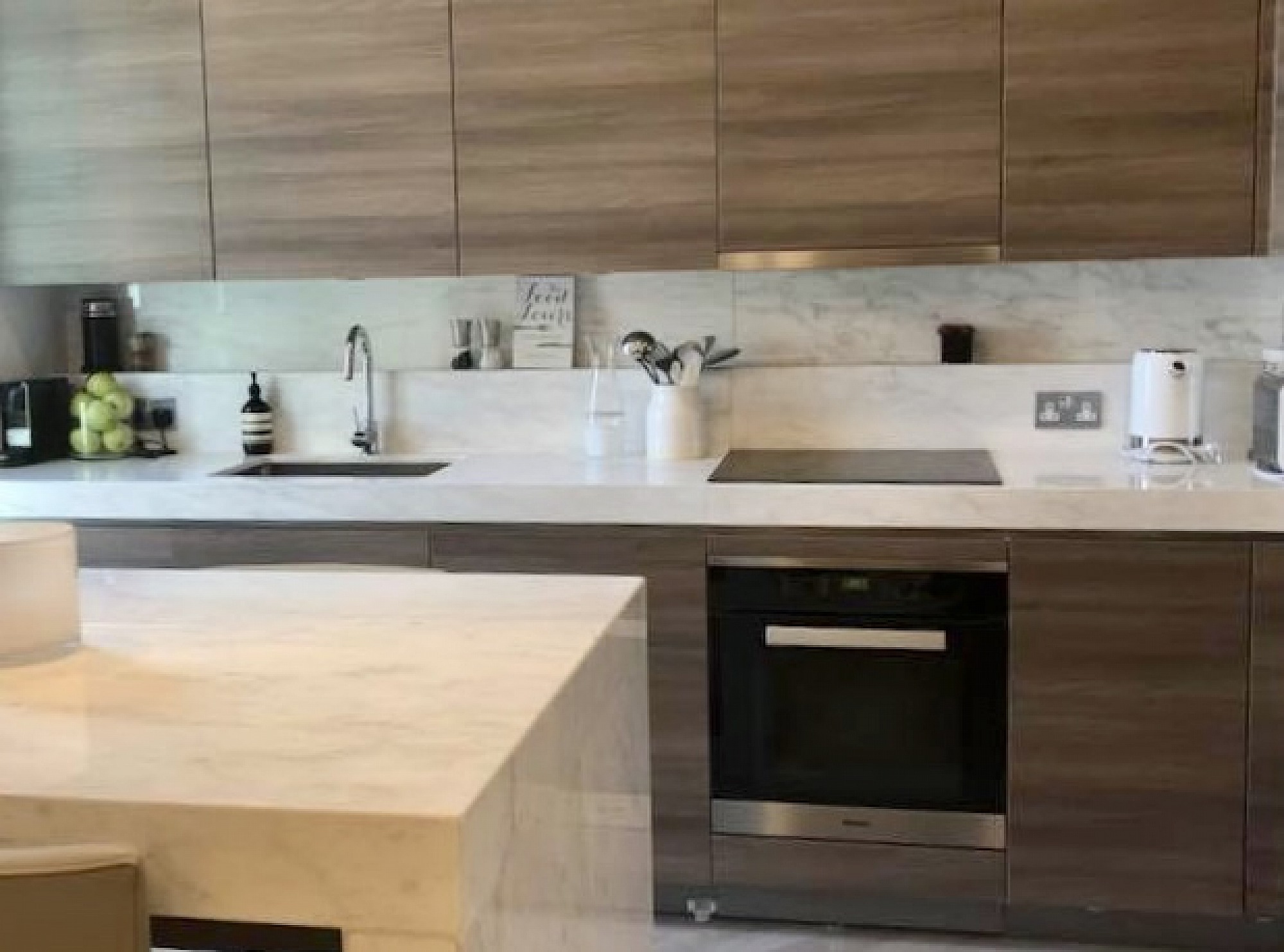 Exclusive designer kitchen marble surfaces South Kensington, with Miele appliances handle-less design in a horizontal veneer cabinets