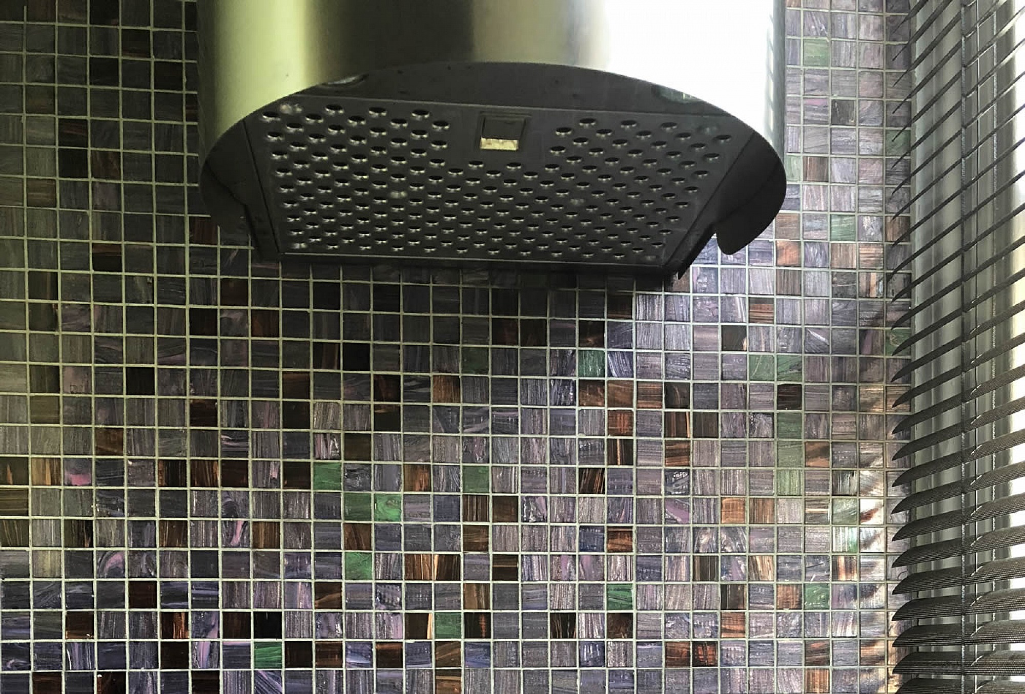 A small bespoke kitchen in Chelsea with Pistachio in high gloss Lacquer integrated Corian sink and Rational furniture, emerald and dark amber Bisazza mosaics