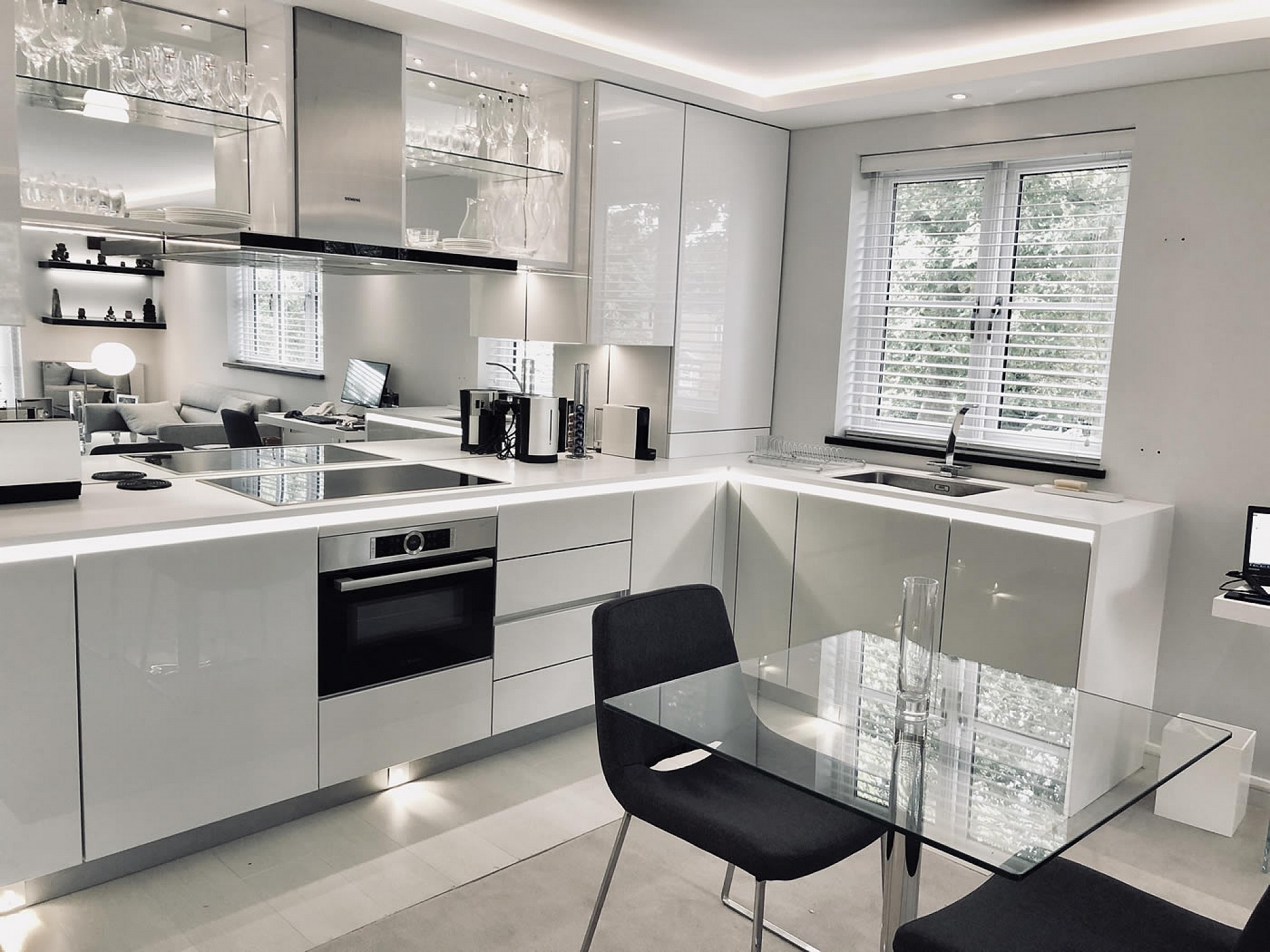 Designer White Kitchen for London pied-a-terre apartment, units are Hacker-Systemat high gloss grey lacquer with the upper units in high gloss white
